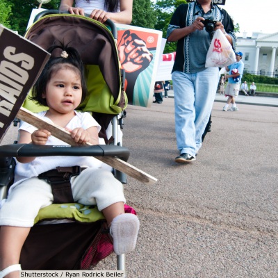 Toddler with immigration reform sign | Shutterstock, Ryan Rodrick Beiler
