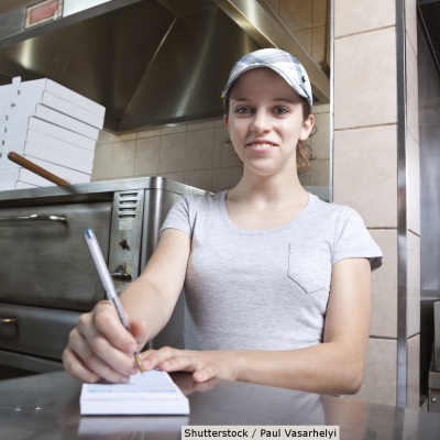 Retail worker taking an order | Shutterstock, Paul Vasarhely