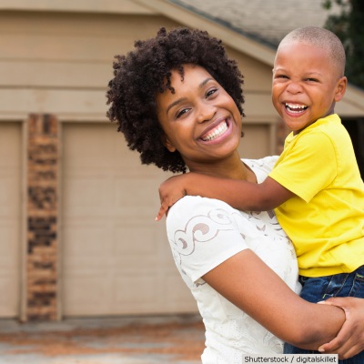 African American mom holding child | Shutterstock, digitalskillet