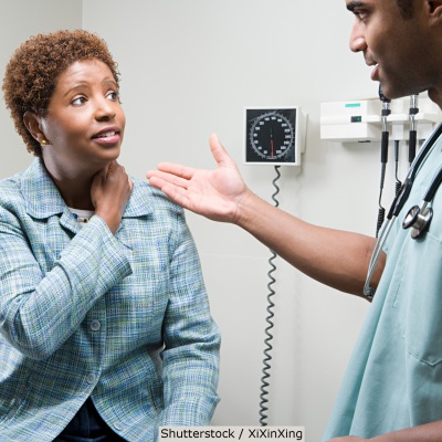 African American woman speaking with doctor | Shutterstock, XiXinXing