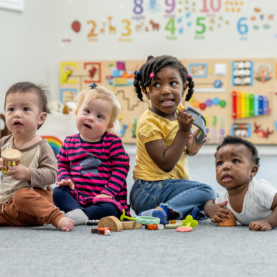 toddlers playing in day care child care early head start looking into the distance