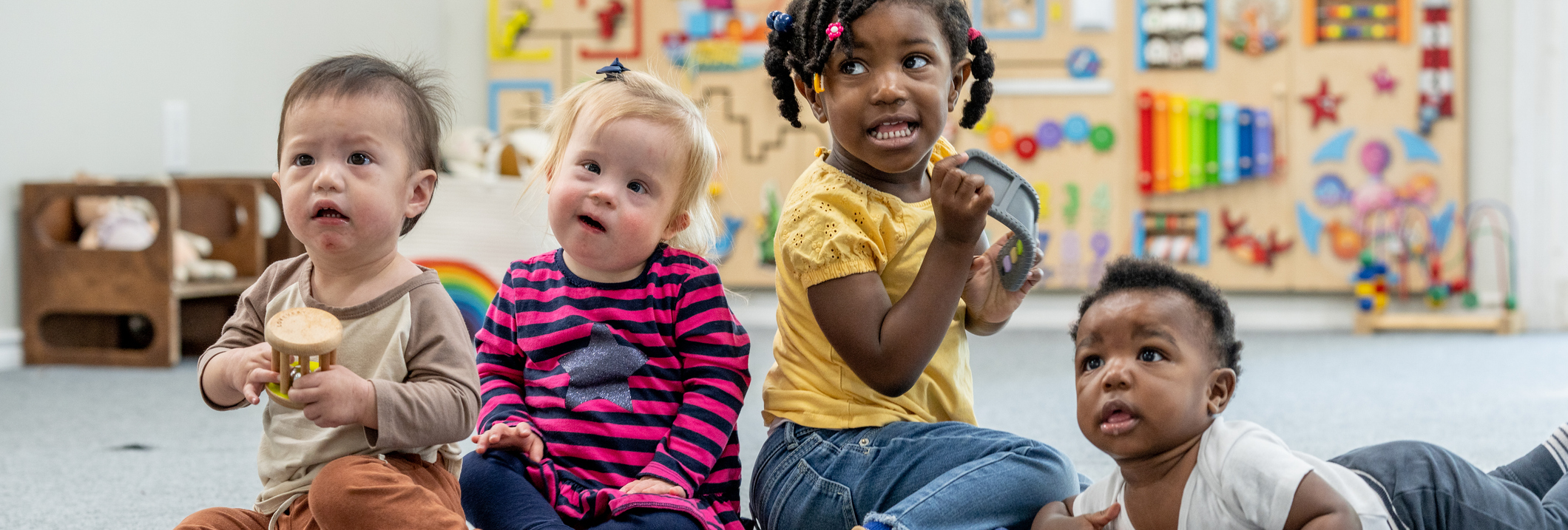 Toddlers playing in daycare, childcare, early head start, looking into the distance. Banner photo for the blog with the new final rules for head start at CLASP.ORG